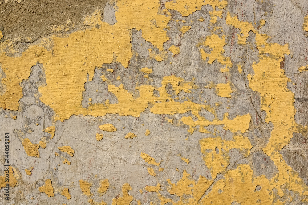 Brown cracked painting on grey concrete surface Brown cracked painting on grey concrete surface