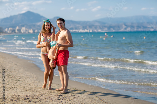 A family is having fun at the seashore of Mediterranean sea © Maygutyak
