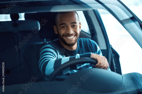 Fototapeta Happy male customer in a newly bought car
