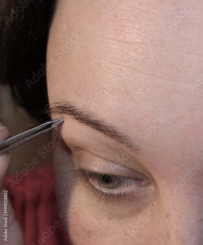 Woman removes facial hair