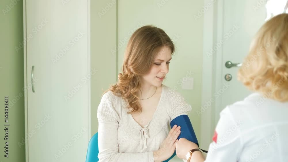 Doctor measuring blood pressure of woman in hospital 4k Doctor measuring blood pressure of woman in hospital 4k