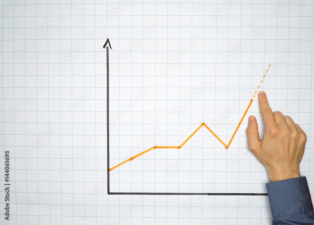 Businessman points an a chart on a flipchart - concept with plenty copyspace Businessman points an a chart on a flipchart - concept with plenty copyspace