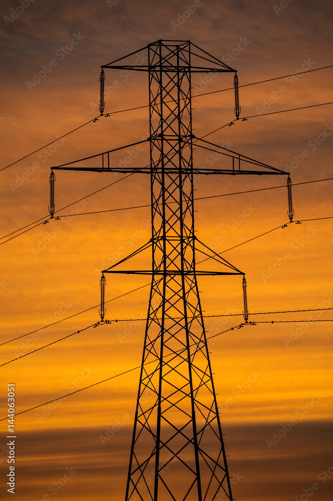 Silhouette of high voltage power lines tower at orange sky dusk sunset ...