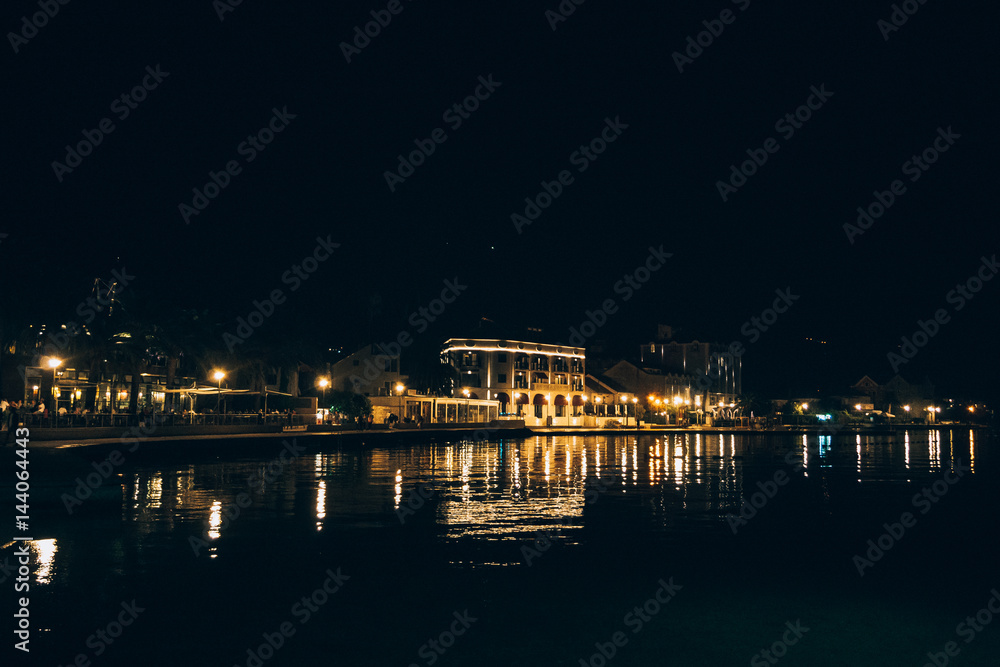 Night Tivat in Montenegro. The embankment of the city at night.