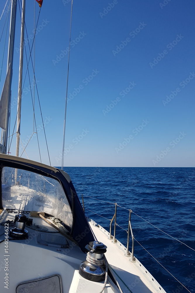 Fototapeta premium Yacht sails on the blue sea