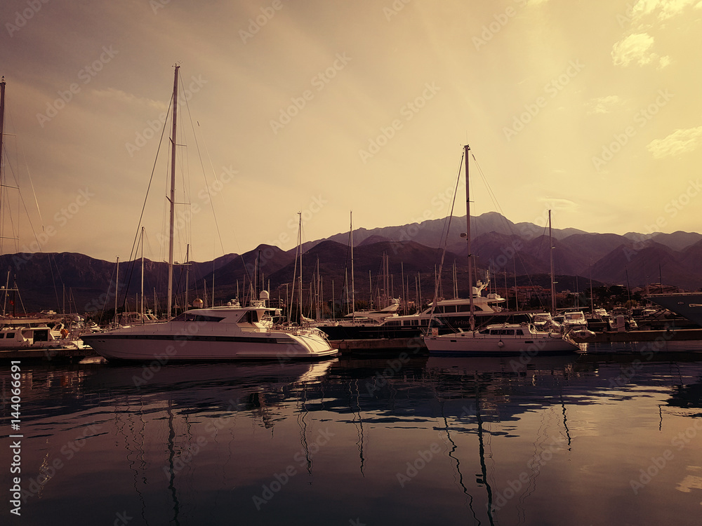 Yachts in the marina at sunrise against the backdrop of the mountains