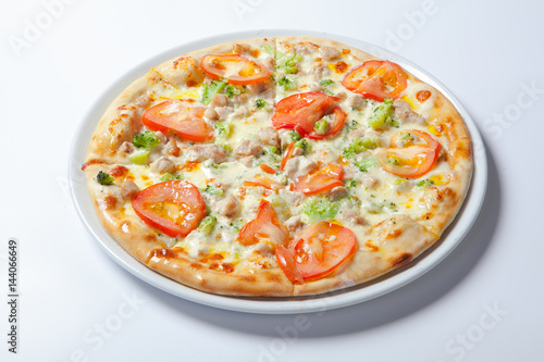 Italian delicious pizza with tomato, broccoli and cheese.