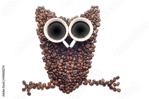 Owl made of coffee beans over white background