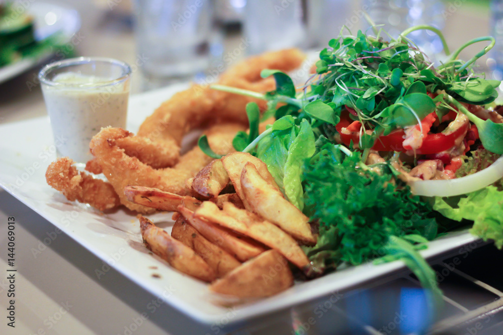 Fried fish, french fries and Vegetable salad.