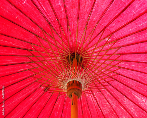 Under red Thai traditional paper umbrella