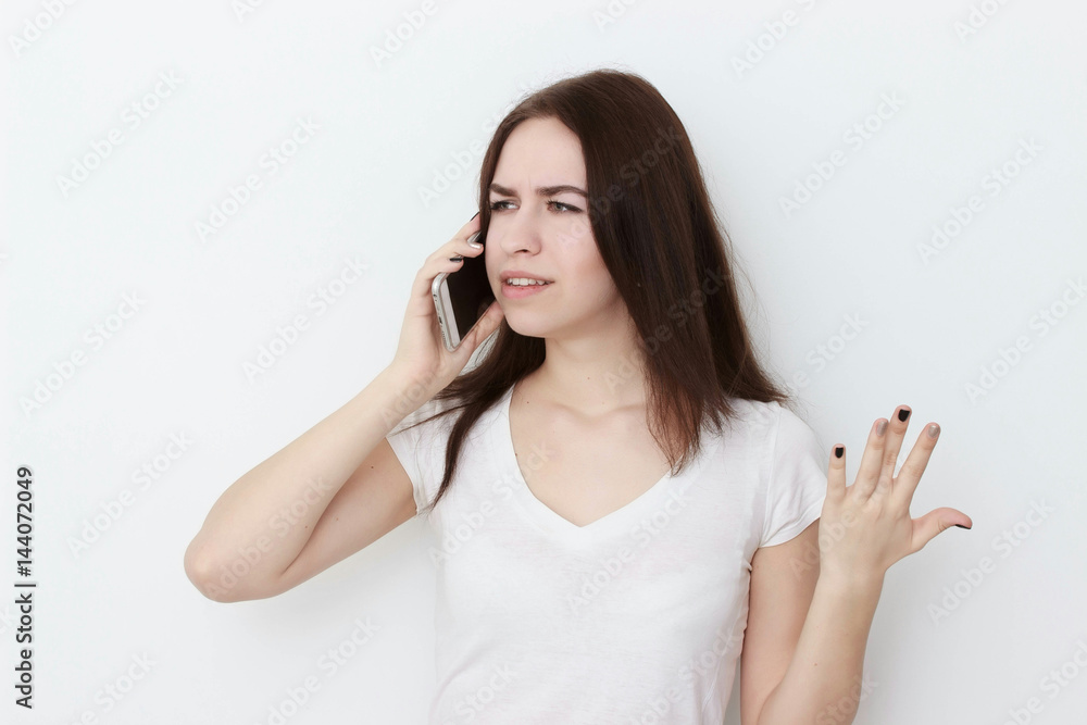 Smiling female student talking on the phone isolated on a white background Smiling female student talking on the phone isolated on a white background