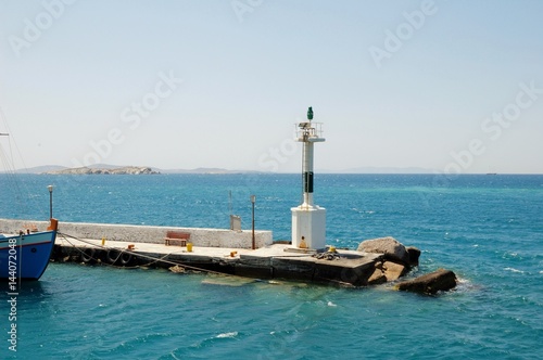 Small lighthouse among the Cycladic Islands. In the Aegean sea. Greece. This place is whittling its simplicity. And very beauty of the sea landscape. From travels in Mediterranean