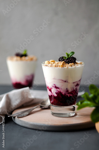 Delicious Breakfast in a glass with granola, yogurt and berries