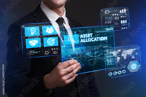Business, Technology, Internet and network concept. Young businessman working on a virtual screen of the future and sees the inscription: Asset allocation