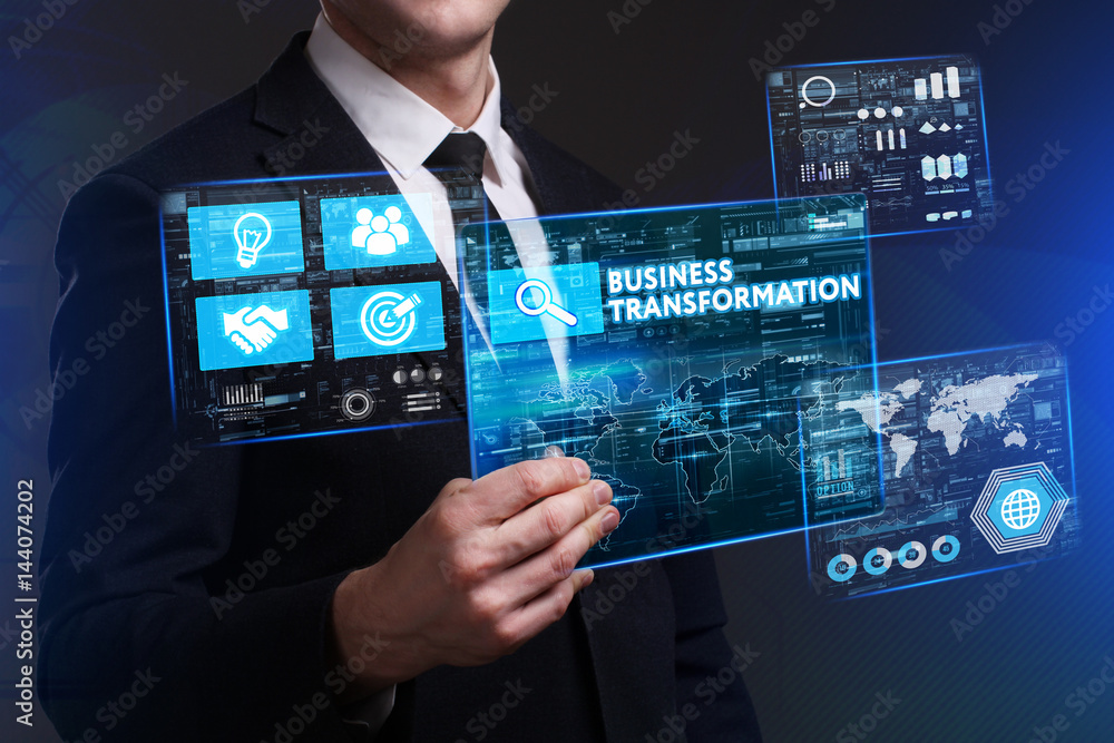 Obraz premium Business, Technology, Internet and network concept. Young businessman working on a virtual screen of the future and sees the inscription: Business transformation