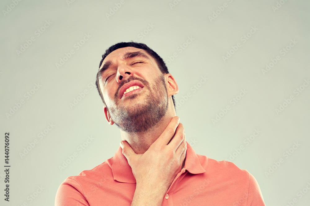 man touching neck and suffering from throat pain man touching neck and suffering from throat pain