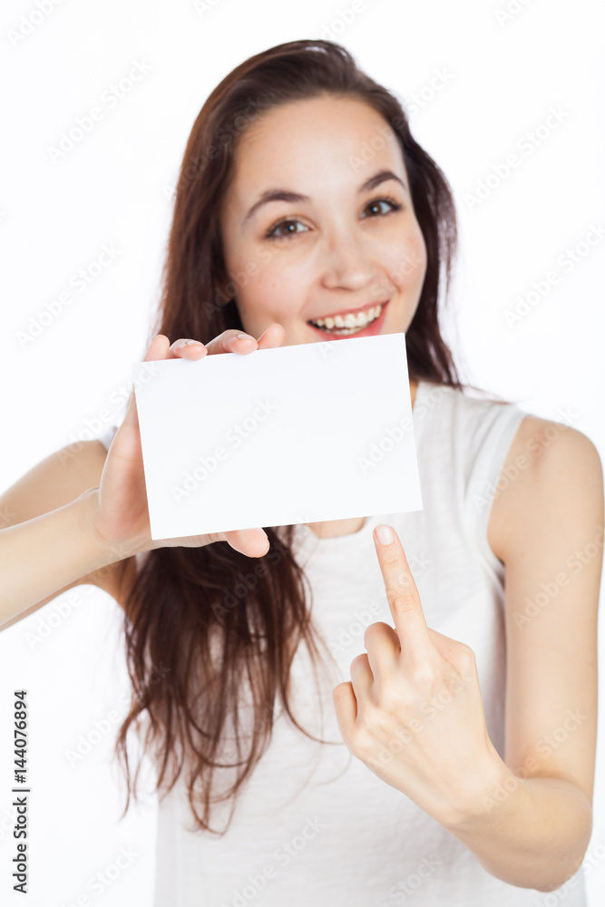 Cute woman pointing at a blank business card Cute woman pointing at a blank business card