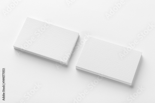 Mockup of two blank horizontal business cards stacks at white textured background. © Mayatnikstudio