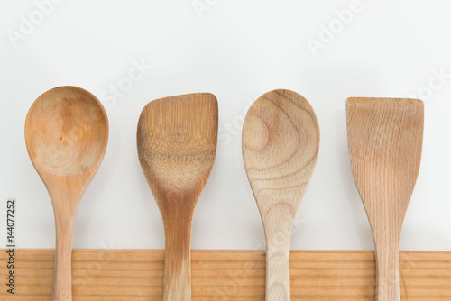 Wooden Spoons on Chopping Board on White Background.