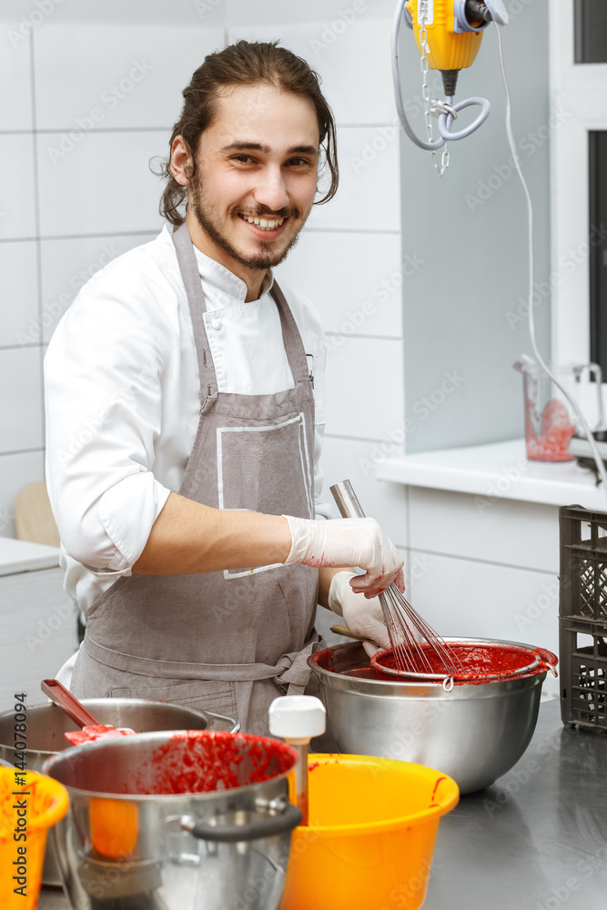 Young handsome cook at the kitchen Young handsome cook at the kitchen