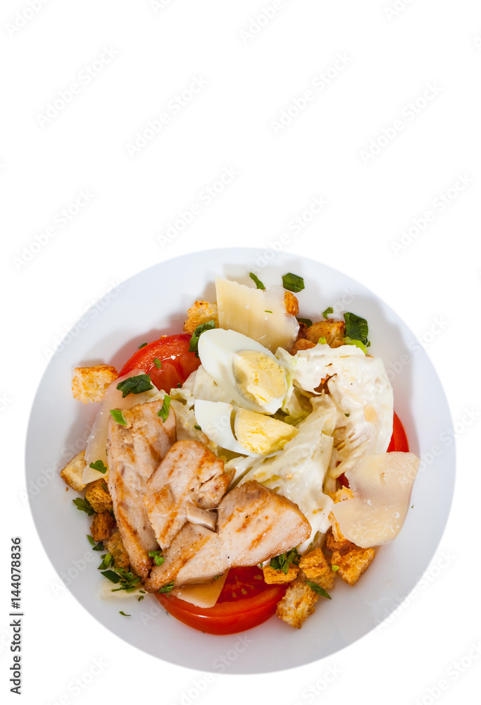 Caesar salad with croutons, cheese, eggs, tomatoes and grilled chicken. top view. isolated on white Caesar salad with croutons, cheese, eggs, tomatoes and grilled chicken. top view. isolated on white