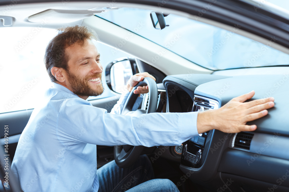 Handsome mature man sitting in a new car Handsome mature man sitting in a new car