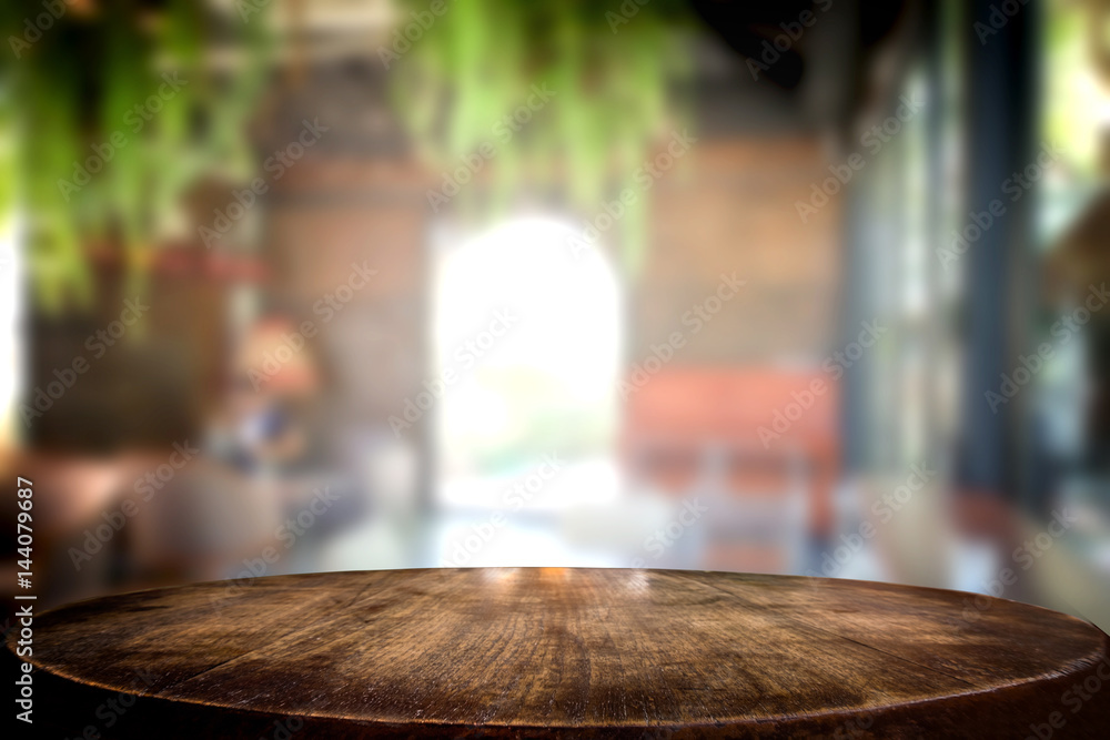 Selected focus empty brown wooden table and coffee shop cafe or restaurant blur background image. for your photomontage or product display Selected focus empty brown wooden table and coffee shop cafe or restaurant blur background image. for your photomontage or product display