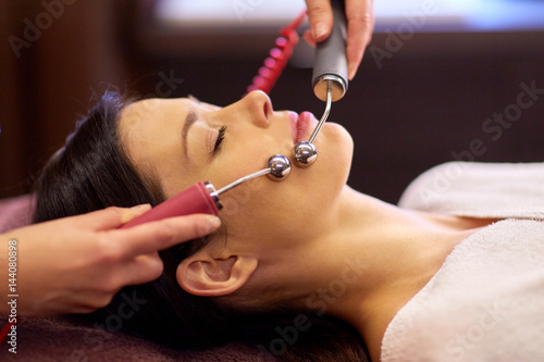 woman having hydradermie facial treatment in spa photo