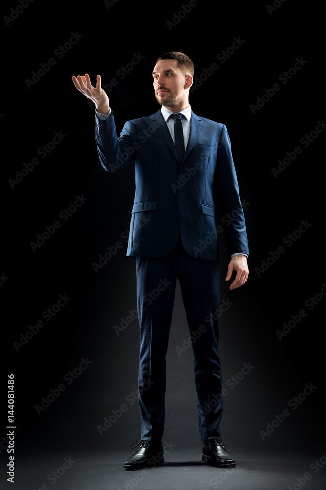 businessman in suit holding something invisible businessman in suit holding something invisible