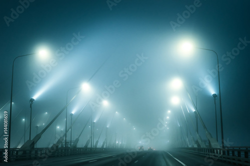 Highway across the bridge in the fog. The road in the fog. traffic trails at caiyuanba yangtze river bridge chongqing china.