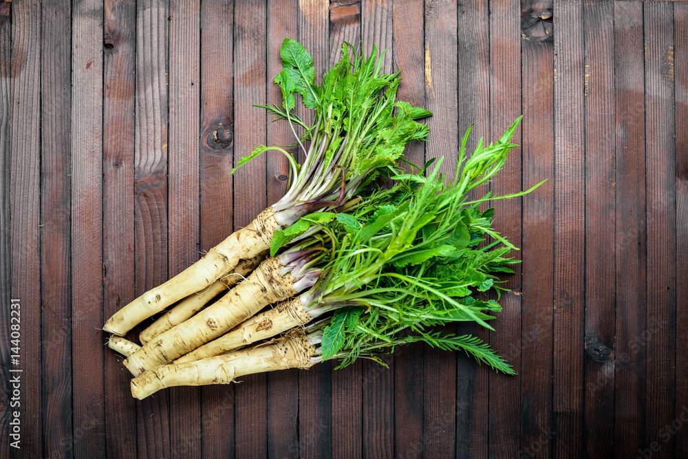 Fresh horseradish. In brown Wooden table. Top view. Fresh horseradish. In brown Wooden table. Top view.