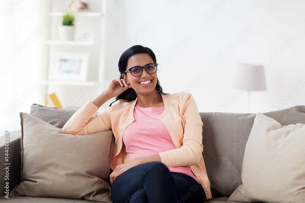 happy smiling young woman sitting on sofa at home happy smiling young woman sitting on sofa at home