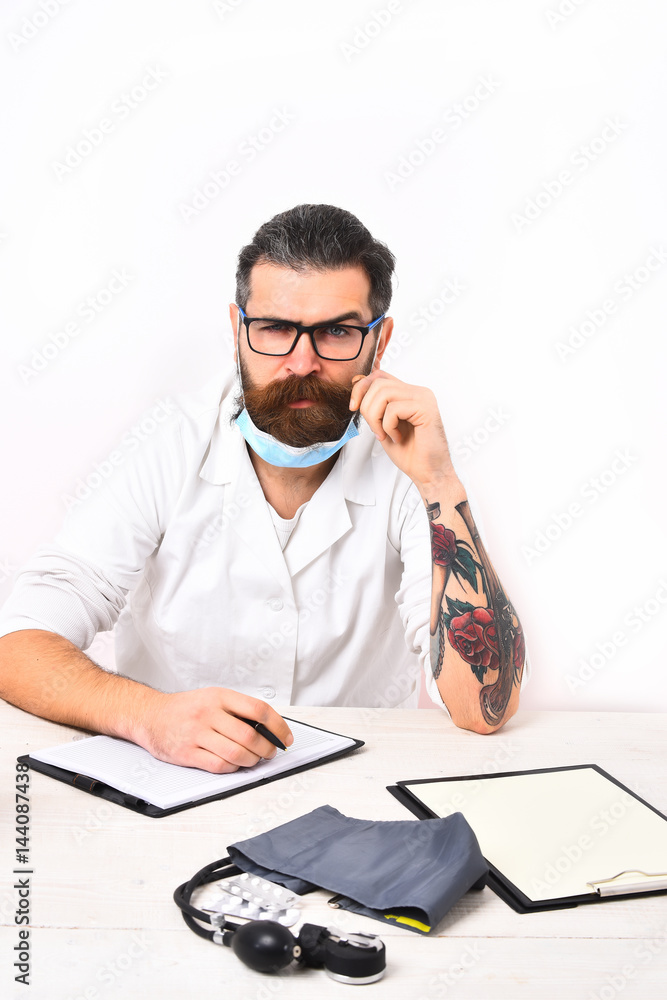 Bearded caucasian doctor sitting at table Bearded caucasian doctor sitting at table