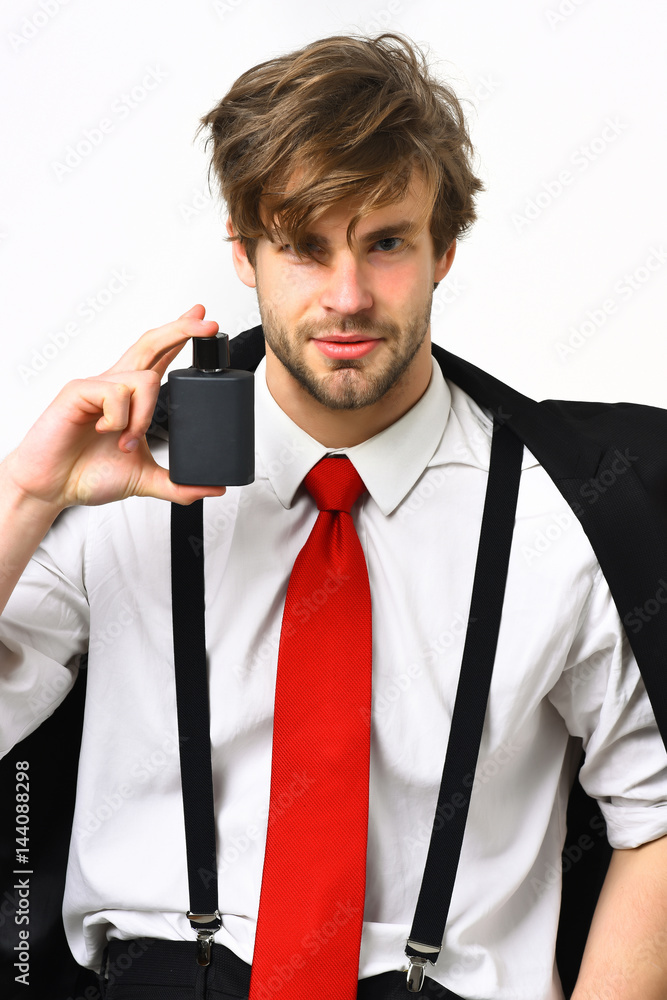 Naklejka premium Caucasian stylish man posing with perfume