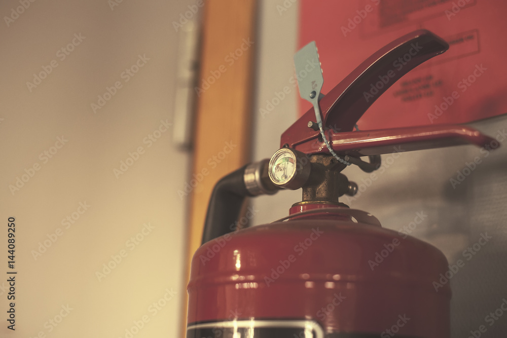 Fire extinguisher with pressure odometer in the gray room Fire extinguisher with pressure odometer in the gray room
