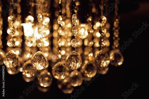 lighting chandelier with hanging lightbulbs, in dark background
