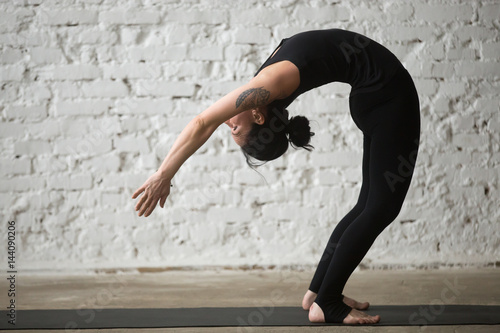 Bilde på lerret Young yogi attractive woman practicing yoga concept, standing Backward Bend exer