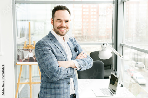 businessman in blue blazer with a laptop