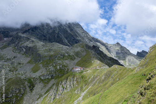 Stubai Alps, Tyrol, Austria. The Innsbrucker Hut, while the peak of the Habicht in the background is veiled by clouds photo