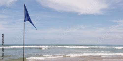 Flag blue and hoisted on the beach symbol of clean water ready for swimming