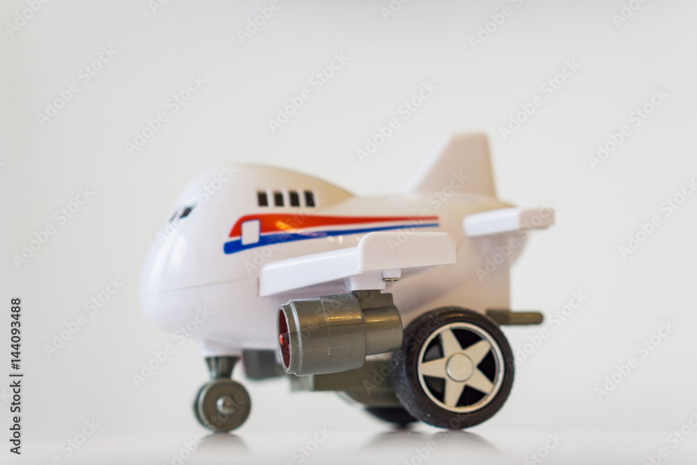 Closeup of white plastic toy airplane on a white table. Closeup of white plastic toy airplane on a white table.