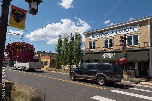 Cars in a traditional street in the historic City of Sisters in Deschutes County, Oregon photo