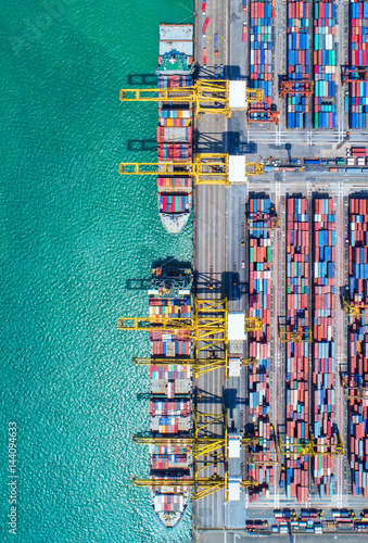 container ship in import export and business logistic.By crane ,Trade Port , Shipping, cargo to harbor, Aerial view, Top view.