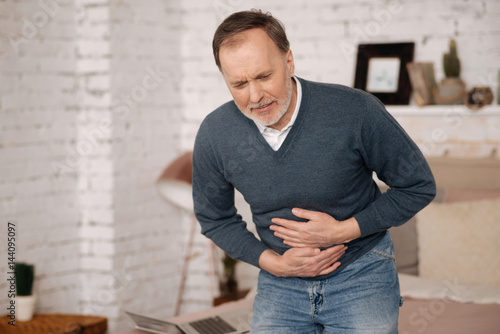 Εκτύπωση καμβά Old man feeling big discomfort in stomach.