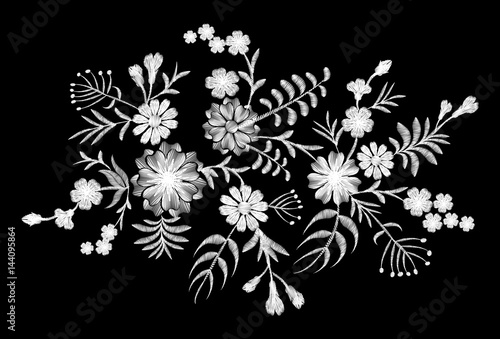 White lace pattern of flowers on a black background. Imitation embroidery. Chamomile, forget-me-not, gerbera, paisley rustic vintage patch neckline vector illustration