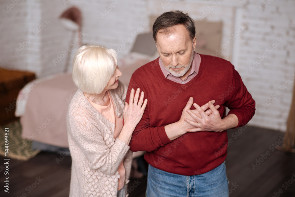 Aged man with heartache near wife Aged man with heartache near wife