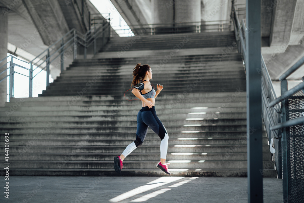 Woman running in urban environment  