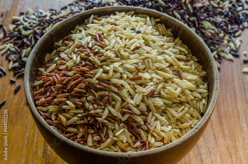 brown rice in wooden bowl