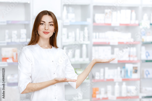 Attractive young pharmacist at work photo