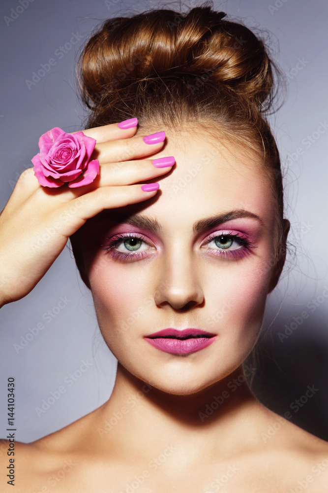 Young beautiful girl with stylish pink manicure and hair bun Young beautiful girl with stylish pink manicure and hair bun